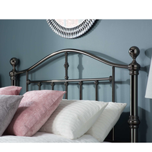 Black nickel bedstead headboard with curved top rail and vertical bars