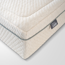 Cream mattress corner detail with 'Natural 1500' label and padded edge