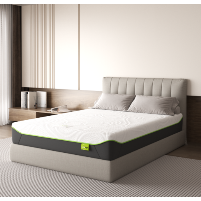 Gray mattress with white top and green trim, on a bed frame