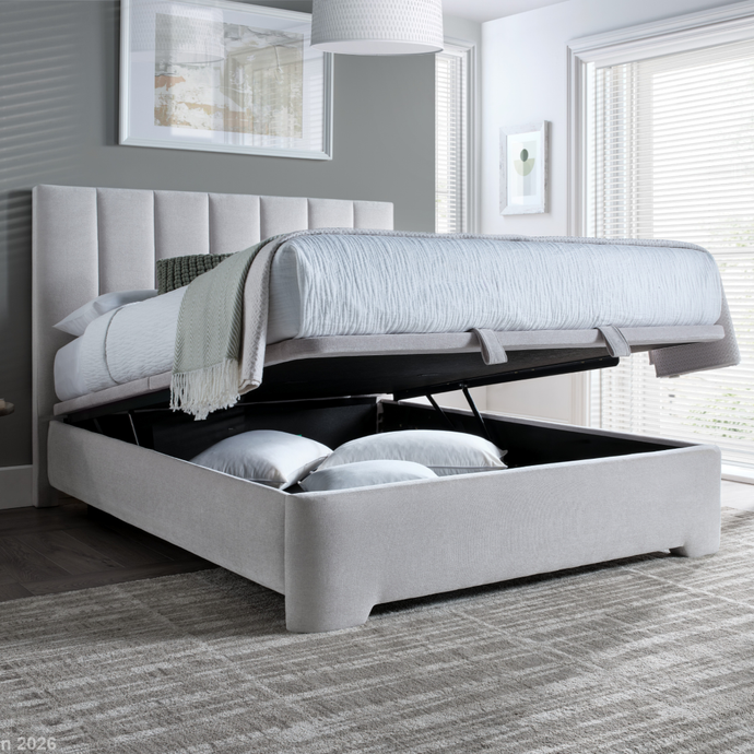 Upholstered ottoman bed with tall vertical channel headboard, light gray fabric, storage base