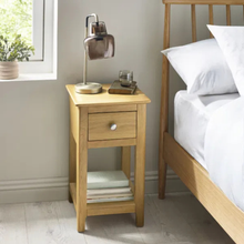 Oak bedside table with single drawer and open shelf, light wood finish