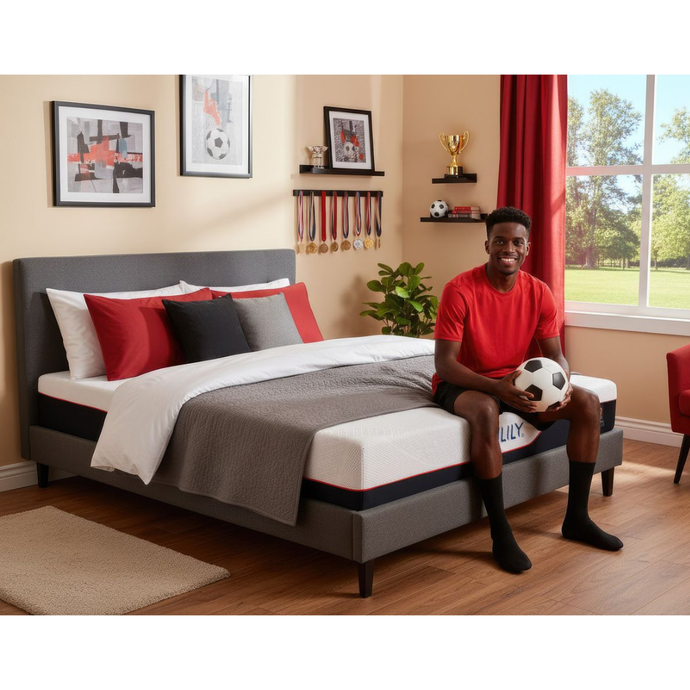 Gray upholstered bed with white mattress and decorative pillows