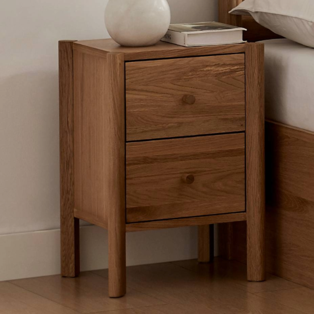 Wooden nightstand with two drawers and rounded knobs, rectangular top.