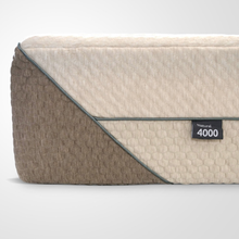 Natural 4000 mattress with cream top layer and brown fabric side, label badge