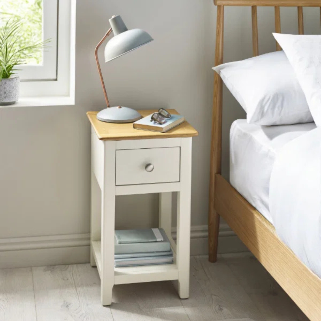 White and oak bedside table with one drawer and lower shelf, round metal knob.