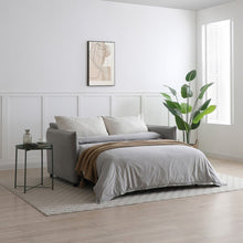 Selma sofa bed in gray fabric with open sleeping surface and headrest pillows