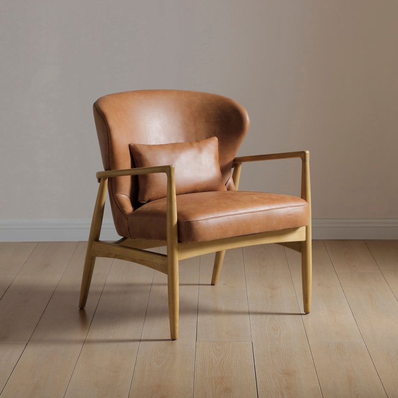 Tan leather armchair with curved arms and light wood legs
