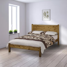 Oak-toned wooden bedstead with slatted headboard and matching footboard, rectangular frame
