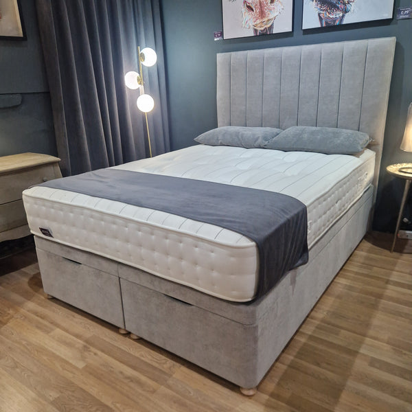 Upholstered double ottoman bed with tall headboard and padded storage base