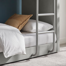 Meadow bunk bed close-up of side guard, ladder rungs, and lower bed frame.