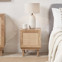 Solid wood bedside table with single door and woven rattan panel