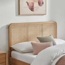 Livia bedframe headboard detail with woven rattan cane, light wood frame, pillows