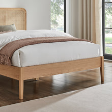 Livia bedframe front rail in light wood with platform base and woven trim, close view