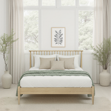 Light oak bedstead with slatted headboard, low footboard, four legs and mattress base