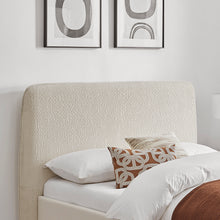 Natural upholstered headboard with white bed base and patterned decorative cushions