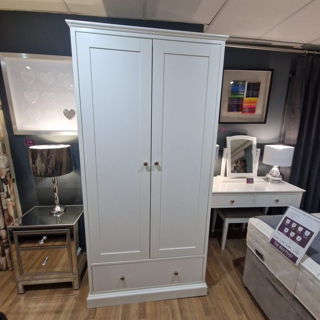 White double wardrobe with two panel doors and round knobs
