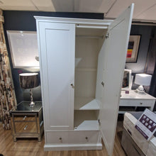 White double wardrobe with open doors and an interior shelf