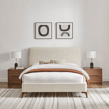 Natural upholstered bedstead with white platform base, tall headboard and wooden legs