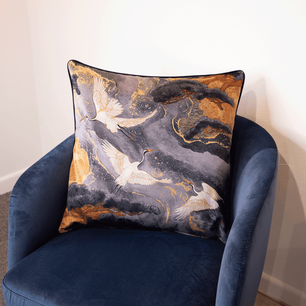 Grey patterned cushion with crane birds and gold accents, square shape