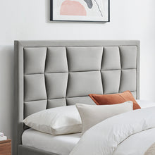 Silver-grey upholstered bedstead with segmented headboard and orange accent pillow