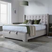 Upholstered ottoman bed with tufted headboard and light gray storage base