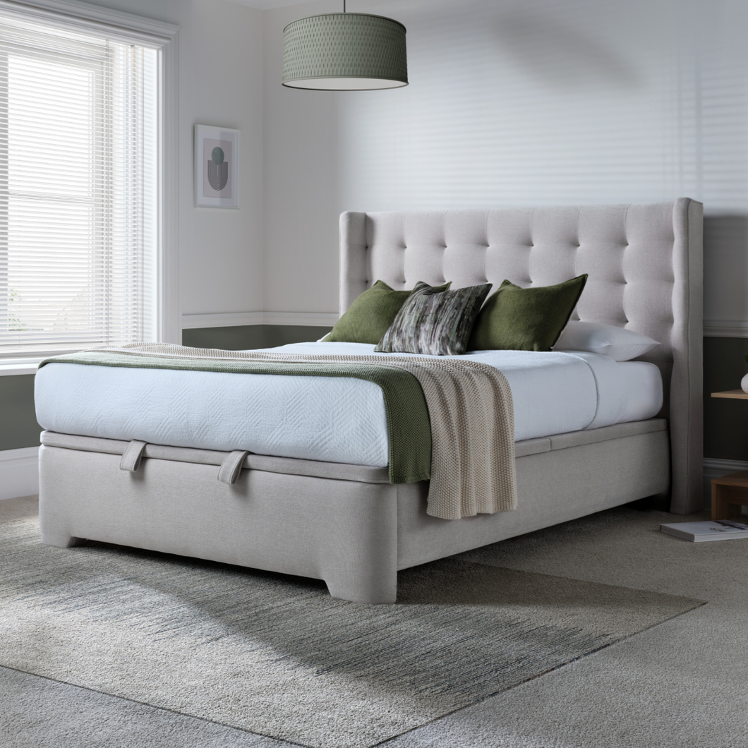 Upholstered ottoman bed with tufted headboard and light gray storage base
