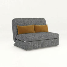 Dark gray sofa bed with two tan throw pillows and textured upholstery