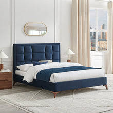 Navy upholstered bedstead with tall segmented headboard and low footboard