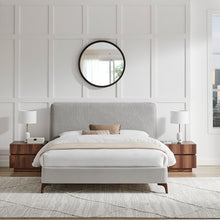 Grey upholstered bedstead with sloped headboard, centered foot panel, wooden legs