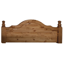 Light brown wooden headboard with curved top rail and turned finials