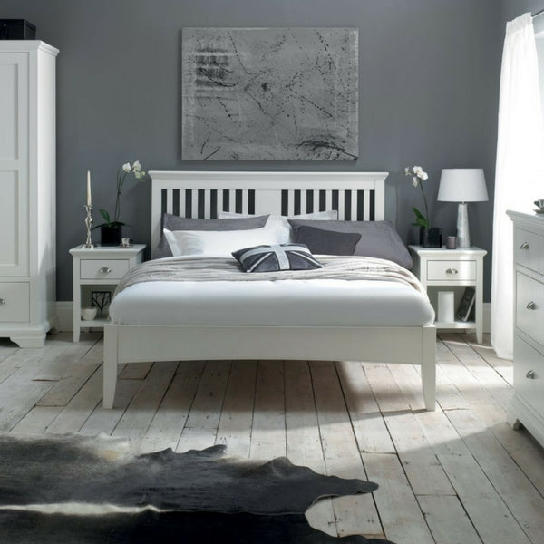 White slatted bedstead with tall headboard and upholstered mattress base